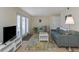 Living room with a sofa, armchair, and access to a balcony at 105 Pompano Se Dr # A, St Petersburg, FL 33705