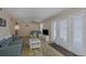Open living area showcasing a sofa, dining nook, and patio access at 105 Pompano Se Dr # A, St Petersburg, FL 33705