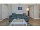 Bright living room featuring a comfy sofa, coffee table, and access to a patio at 105 Pompano Se Dr # A, St Petersburg, FL 33705
