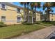 Building exterior showcasing its yellow facade and landscaping at 105 Pompano Se Dr # A, St Petersburg, FL 33705