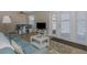 Open living area with sofa, dining area and access to a patio at 105 Pompano Se Dr # A, St Petersburg, FL 33705