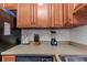 Kitchen counter with wood cabinets, appliances, and cookware at 105 Pompano Se Dr # A, St Petersburg, FL 33705
