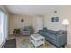 Living room featuring a sofa, armchair, and balcony access at 105 Pompano Se Dr # A, St Petersburg, FL 33705