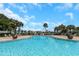 Relaxing community pool with surrounding palm trees at 105 Pompano Se Dr # A, St Petersburg, FL 33705