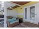 Ground level patio with wicker furniture, grill, and access to the interior at 105 Pompano Se Dr # A, St Petersburg, FL 33705