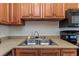 Modern kitchen sink with double basins and wood cabinets at 105 Pompano Se Dr # A, St Petersburg, FL 33705