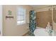Bathroom with tub, shower, and tropical decor at 105 Pompano Se Dr # A, St Petersburg, FL 33705