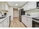 Condo kitchen with white cabinets and stainless steel appliances at 36750 Us Highway 19 N # 05102, Palm Harbor, FL 34684