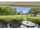 Private patio with seating and lush landscaping views at 36750 Us Highway 19 N # 05102, Palm Harbor, FL 34684