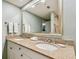 Double vanity bathroom with granite countertop and large mirror at 36750 Us Highway 19 N # 05102, Palm Harbor, FL 34684