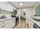Condo kitchen with white cabinets and stainless steel appliances at 36750 Us Highway 19 N # 05102, Palm Harbor, FL 34684