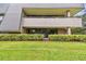 Exterior view of building with patio and landscaping at 36750 Us Highway 19 N # 05102, Palm Harbor, FL 34684