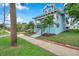 Light blue house with a front porch, walkway, and street view at 222 Hope St, Tarpon Springs, FL 34689