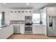 Modern kitchen with white cabinets, stainless steel appliances, and a quartz countertop at 222 Hope St, Tarpon Springs, FL 34689