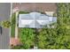 Top-down view of a house with a metal roof, surrounded by trees at 222 Hope St, Tarpon Springs, FL 34689