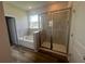 Modern bathroom boasts a glass-enclosed shower and a separate soaking tub beneath a bright window at 16044 7Th E Ave, Bradenton, FL 34212