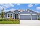 Charming single-Gathering home with a three-car garage, stone accents and well-maintained landscaping at 16044 7Th E Ave, Bradenton, FL 34212
