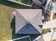 Aerial top-down view of the roof, yard, and surrounding neighborhood at 4744 Woods Landing Ln, Tampa, FL 33619