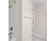 Bathroom with shower featuring tile surround and modern fixtures at 4744 Woods Landing Ln, Tampa, FL 33619