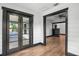 Sunroom features French doors, hardwood floors, and window seat at 2111 Burlington N Ave, St Petersburg, FL 33713