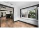 Sunroom with hardwood floors, windows, and access to backyard at 2111 Burlington N Ave, St Petersburg, FL 33713