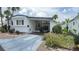 Inviting home featuring covered parking, a cozy porch area, and colorful flowers enhancing its curb appeal at 4851 W Gandy Blvd # B11L35, Tampa, FL 33611