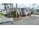 Well-maintained single-story home with a landscaped front yard, featuring tropical plants and a charming exterior at 4851 W Gandy Blvd # B11L35, Tampa, FL 33611