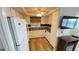 Bright kitchen featuring white cabinets, stainless steel appliances, and convenient access to the living area at 4851 W Gandy Blvd # B11L35, Tampa, FL 33611