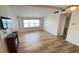 Inviting living room with modern wood floors, a cozy electric fireplace, and a large window at 4851 W Gandy Blvd # B11L35, Tampa, FL 33611