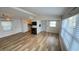 Open-concept living space with wood floors, an electric fireplace, and seamless flow to the adjacent rooms at 4851 W Gandy Blvd # B11L35, Tampa, FL 33611