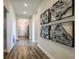 Bright hallway with wood-look flooring and wall art at 14481 Meadowbird Ave, Riverview, FL 33579