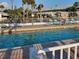 Inviting community pool with lounge chairs and palm trees at 4851 W Gandy Blvd # B11L35, Tampa, FL 33611