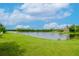 Peaceful lake view from the backyard, offering serenity at 1307 Pasadena Bloom Ln, Ruskin, FL 33570