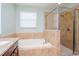 Bathroom with soaking tub and walk in shower at 1307 Pasadena Bloom Ln, Ruskin, FL 33570