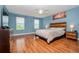 Main bedroom with wood flooring, ceiling fan, and large windows at 1307 Pasadena Bloom Ln, Ruskin, FL 33570