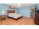 Main bedroom with wood flooring, ceiling fan and access to hallway at 1307 Pasadena Bloom Ln, Ruskin, FL 33570