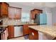 Modern kitchen with granite countertops, stainless steel appliances, and light wood cabinets at 1307 Pasadena Bloom Ln, Ruskin, FL 33570