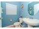 Clean bathroom with toilet, sink, and oval mirror at 1307 Pasadena Bloom Ln, Ruskin, FL 33570