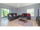 Relaxing living room with sectional sofa, coffee table, and access to patio at 1307 Pasadena Bloom Ln, Ruskin, FL 33570