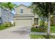Two-story house with a landscaped yard and attached garage at 1307 Pasadena Bloom Ln, Ruskin, FL 33570