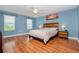 Main bedroom with wood flooring, ceiling fan and large windows at 1307 Pasadena Bloom Ln, Ruskin, FL 33570