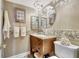 Updated bathroom with a stone-tiled vanity and a modern chandelier at 660 Island Way # 506, Clearwater Beach, FL 33767