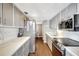 Modern kitchen with stainless steel appliances and white quartz countertops at 660 Island Way # 506, Clearwater Beach, FL 33767