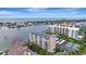 Aerial view of waterfront condo building with tennis courts and marina at 660 Island Way # 506, Clearwater Beach, FL 33767
