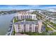 Aerial view of waterfront community with tennis courts, pool, and boat slips at 660 Island Way # 506, Clearwater Beach, FL 33767