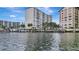 Waterfront view of condo building with boat slips at 660 Island Way # 506, Clearwater Beach, FL 33767