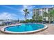 Inviting kidney-shaped pool with lounge chairs and waterfront views at 660 Island Way # 506, Clearwater Beach, FL 33767