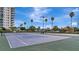 Two tennis courts nestled in a tropical setting next to condo building at 660 Island Way # 506, Clearwater Beach, FL 33767