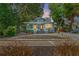 Charming bungalow with light blue siding, mature landscaping, and a welcoming front porch at 2111 Burlington N Ave, St Petersburg, FL 33713