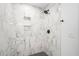 Clean shower with marble tile and hexagon floor at 2111 Burlington N Ave, St Petersburg, FL 33713